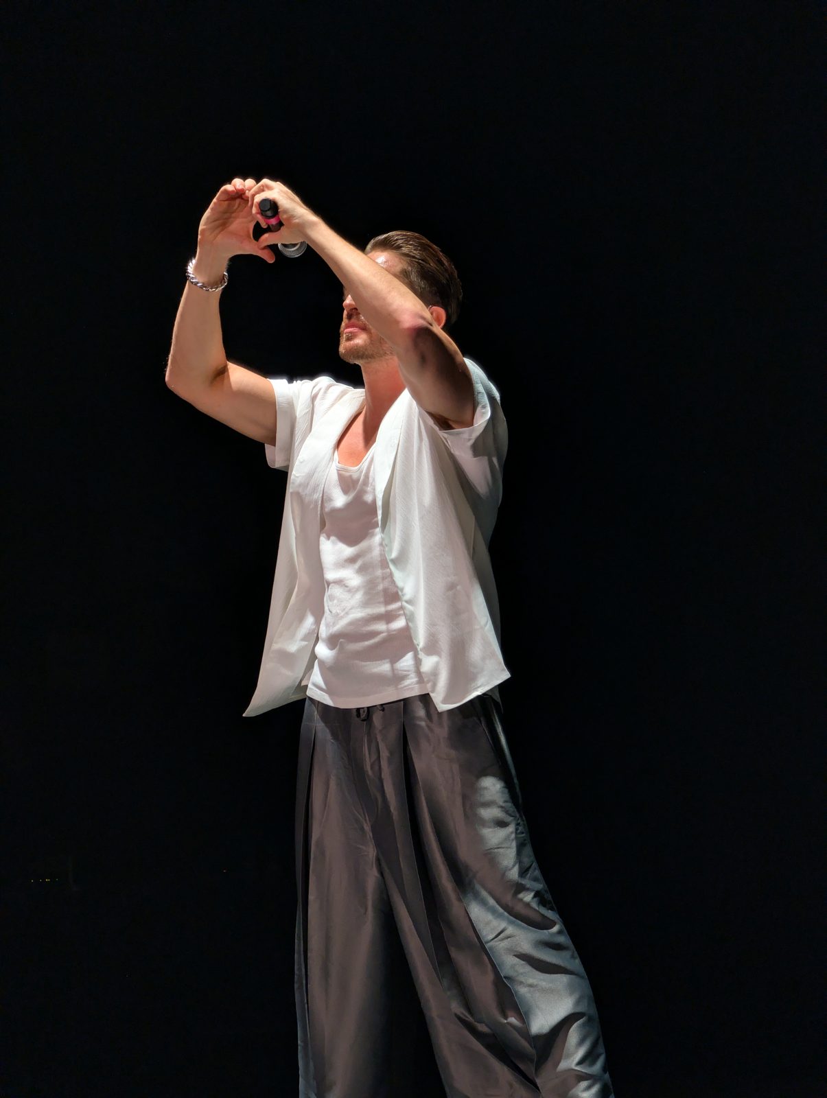 A*Teens member making a heart shape with both hands on stage in Buenos Aires, 2025