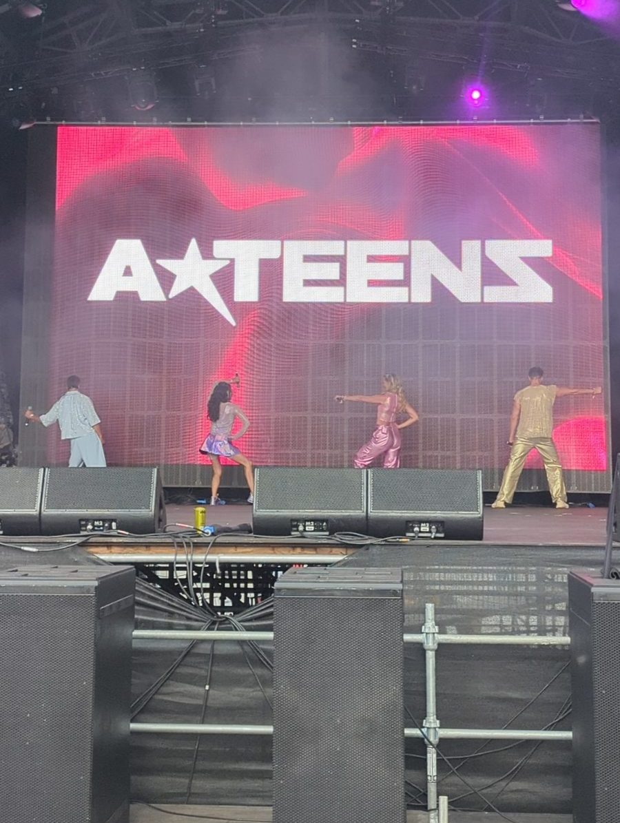 A*Teens performing on the Mighty Hoopla festival stage in London, 2025, with the A*Teens logo on the screen behind them