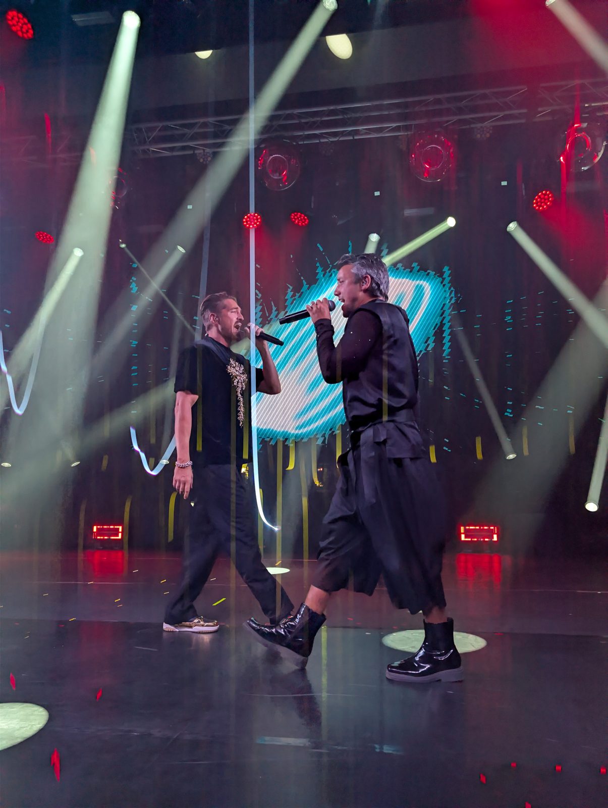 Two A*Teens members singing face to face on stage in Mexico City, 2025
