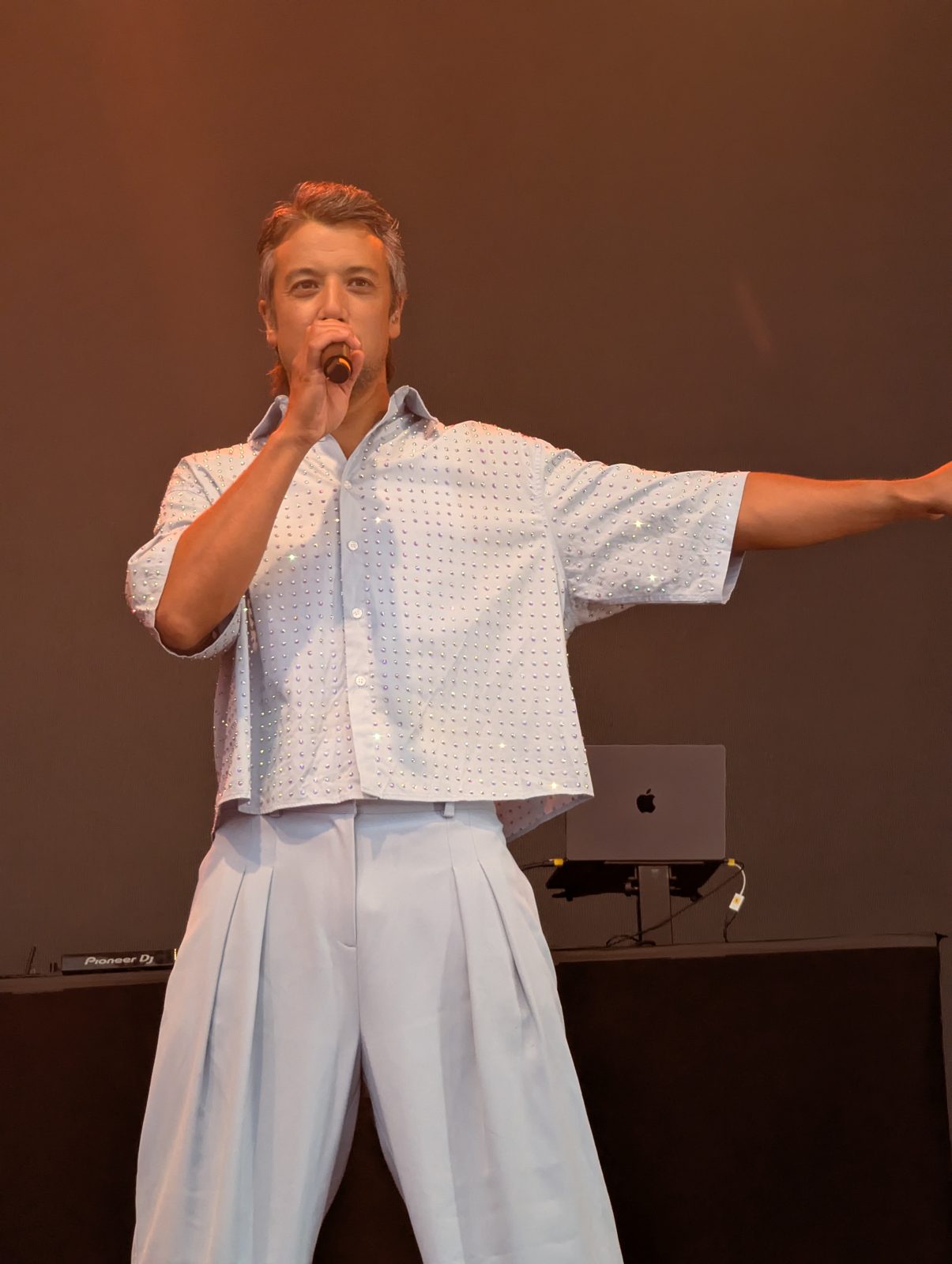 A*Teens member singing with arm outstretched on stage in Oslo, 2025