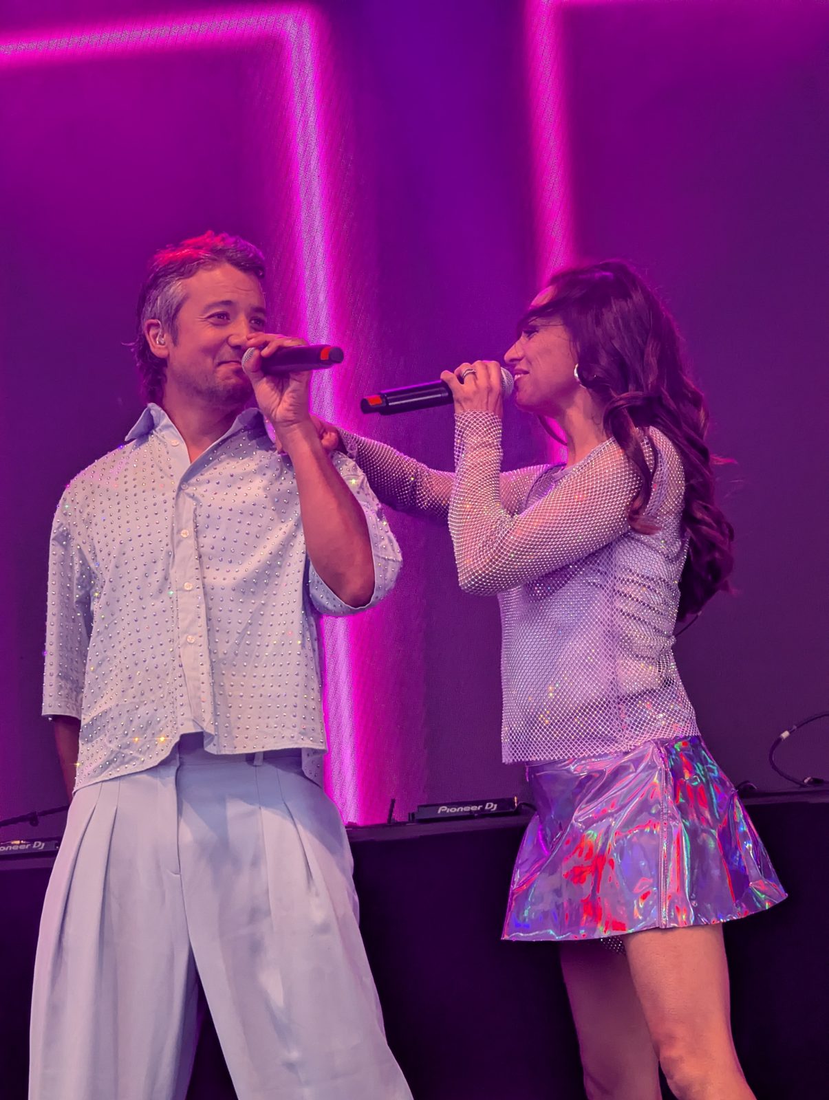 Two A*Teens members singing face to face on stage in Oslo, 2025