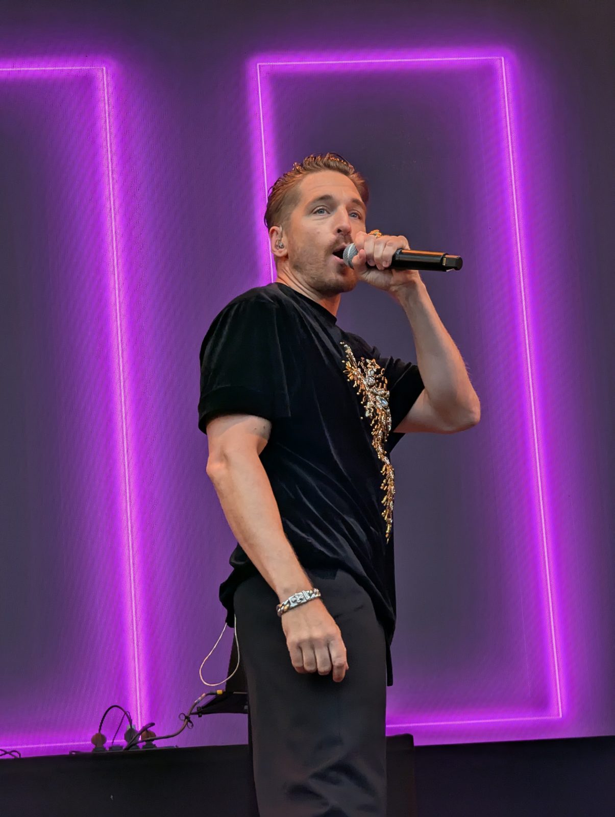 A*Teens member performing in front of neon stage lighting in Trondheim, 2025
